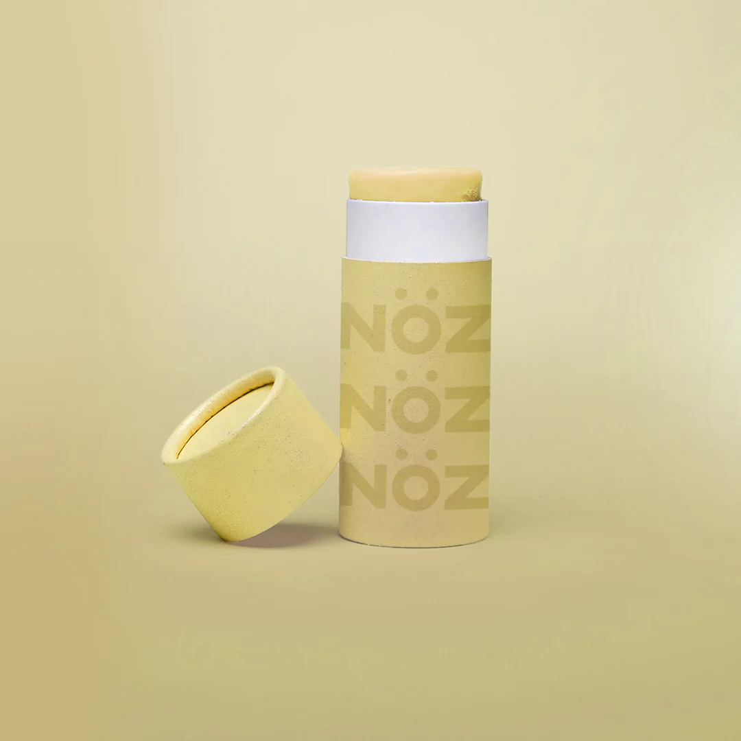 Close up view of NOZ roll up sunscreen in light yellow. 